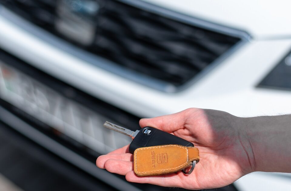 a person holding a car key in their hand
